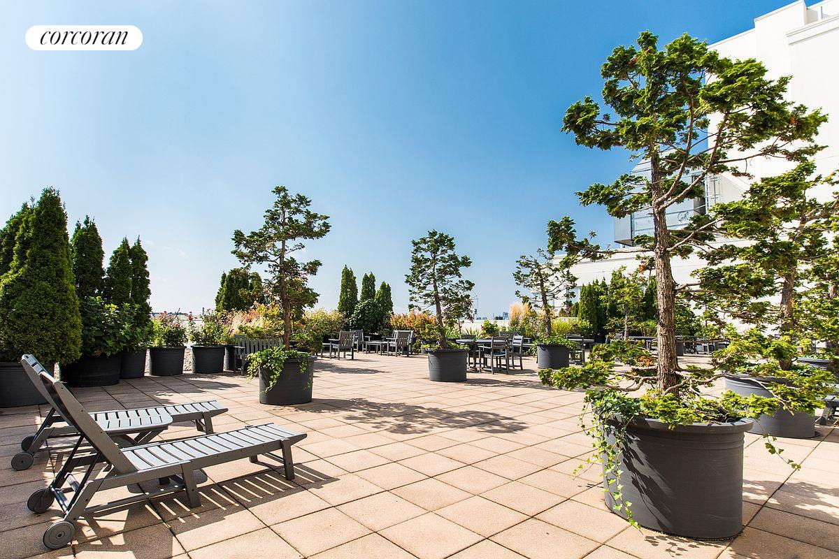 27-28 Thomson Avenue, Unit 228 Queens, NY 11101 - Photo 11 of 17 a view of a backyard with sitting area