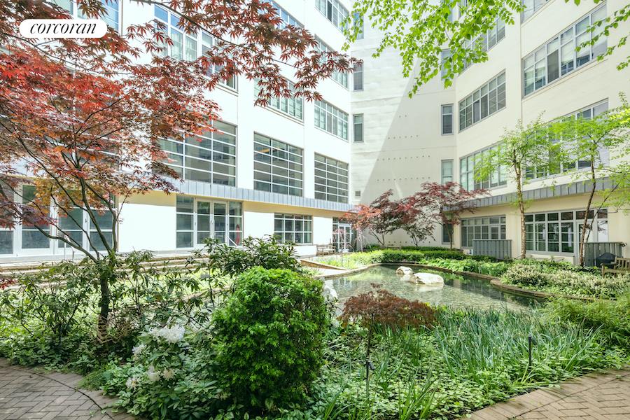 27-28 Thomson Avenue, Unit 228 Queens, NY 11101 - Photo 14 of 17 front view of a building with a garden