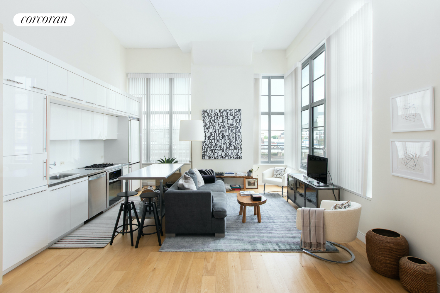 27-28 Thomson Avenue, Unit 228 Queens, NY 11101 - Photo 2 of 17 a living room with furniture wooden floor and a table