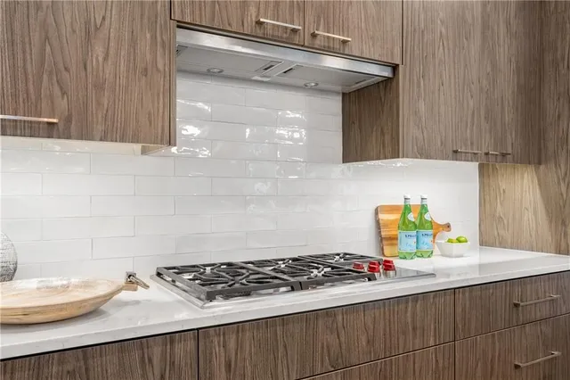 a kitchen with a sink a stove cabinets and a counter top
