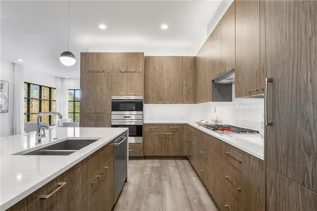 a kitchen with a sink stove and cabinets