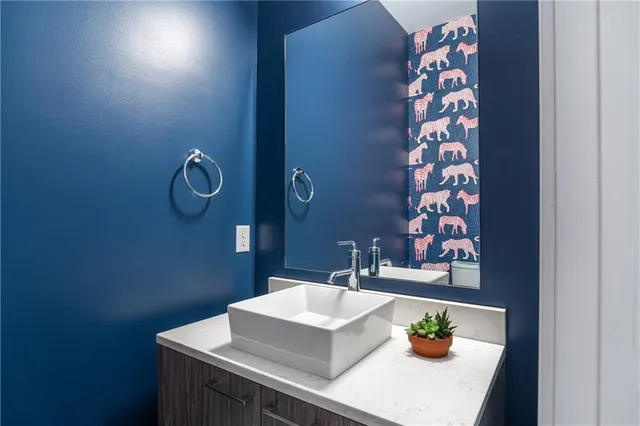 a bathroom with a sink a vanity and a toilet