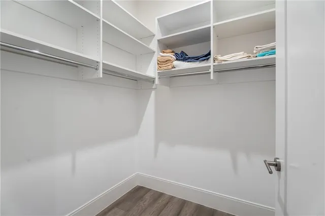 a view of walk in closet with empty racks
