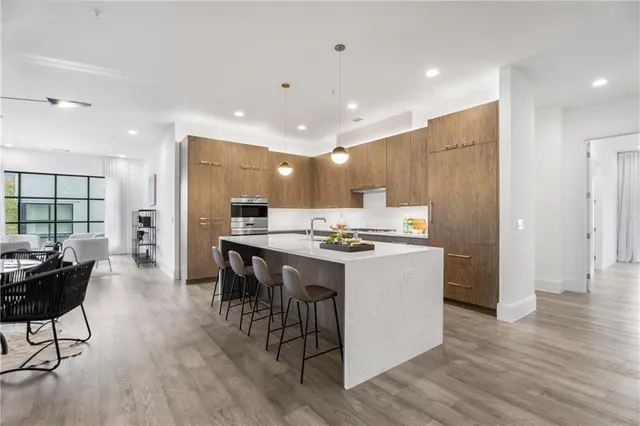 a large kitchen with a table and chairs