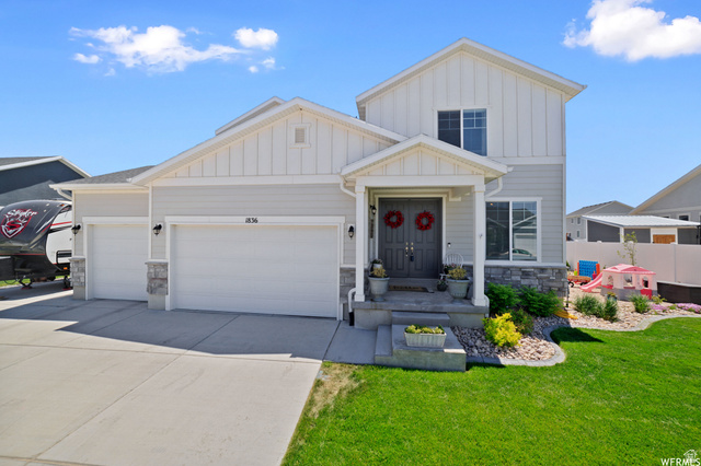 1836 Red Oak Road Eagle Mountain, UT 84005 - Photo 1 of 15 View of front of property with board and batten siding, stone siding, a garage, and driveway