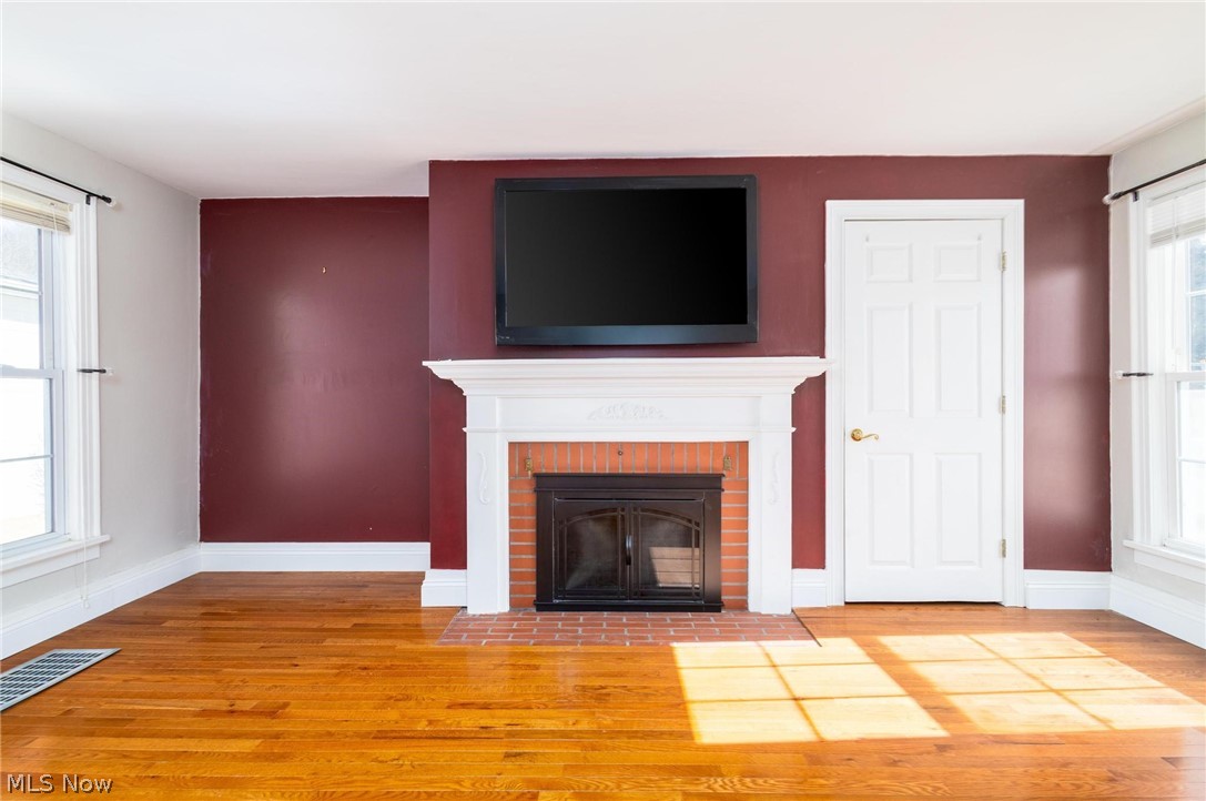 165 9th Street Wellsburg, WV 26070 - Photo 14 of 37 Unfurnished living room with wood finished floors and a brick fireplace