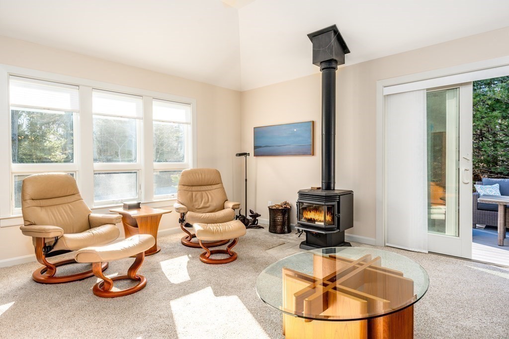 288 Training Field Road Chatham, MA 02633 - Photo 3 of 27 a living room with furniture a fireplace and a flat screen tv