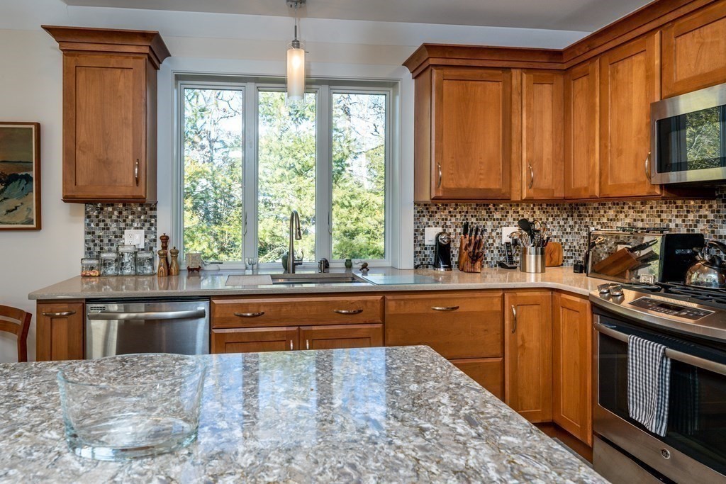 288 Training Field Road Chatham, MA 02633 - Photo 7 of 27 a kitchen with stainless steel appliances granite countertop a stove a sink and a microwave