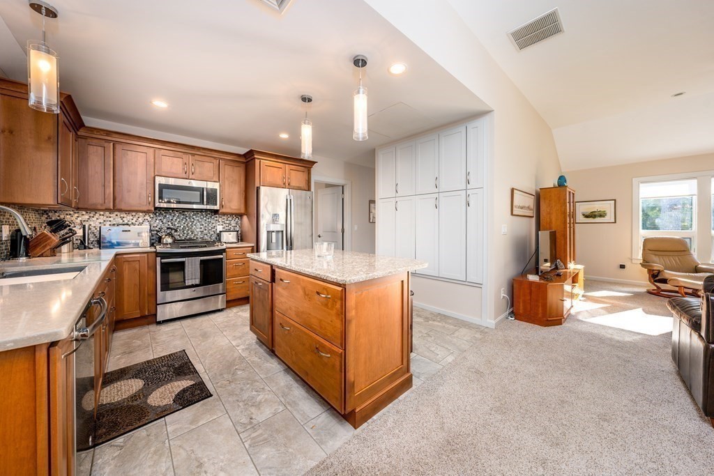 288 Training Field Road Chatham, MA 02633 - Photo 8 of 27 a kitchen with stainless steel appliances granite countertop a stove sink and cabinets
