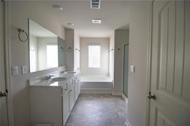 a bathroom with a granite countertop sink a toilet and shower