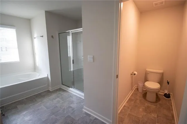 a bathroom with a toilet a sink and a bathtub