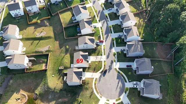 an aerial view of a houses with yard swimming pool and outdoor seating