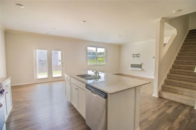 a kitchen with sink cabinets and wooden floor