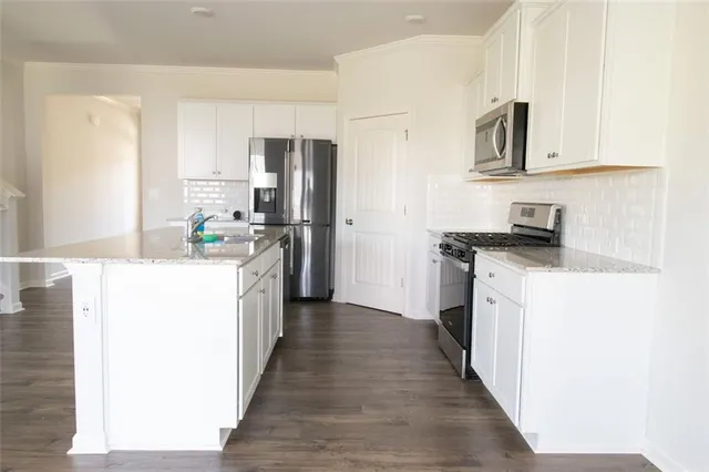 a kitchen with stainless steel appliances a refrigerator stove microwave and sink