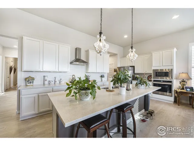 a kitchen with kitchen island a sink counter and chairs