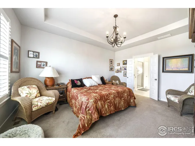 a bedroom with two beds and a chandelier