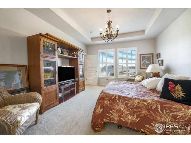 a spacious bedroom with a bed and glass windows