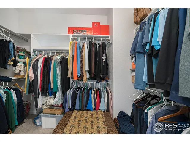 a view of walk in closet with clothes