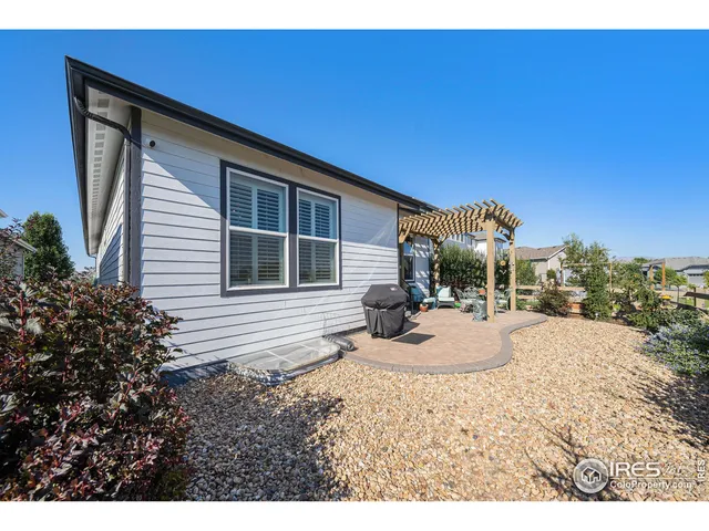 a view of a patio with furniture and a yard