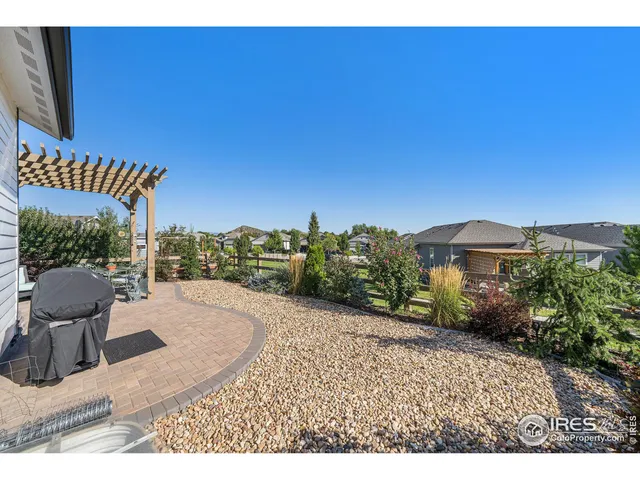an aerial view of residential houses with outdoor space and lake view