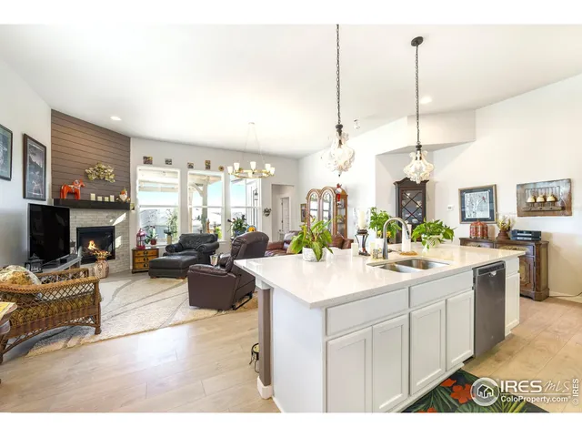 a kitchen with a stove a refrigerator a kitchen island a dining table and chairs