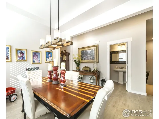 a living room with furniture a chandelier and a dining table