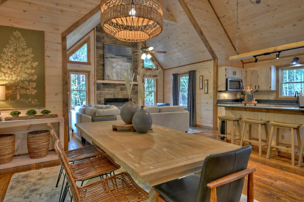 135 Windy Valley Lane Blue Ridge, GA 30513 - Photo 14 of 63 a view of a dining room with furniture a chandelier and wooden floor