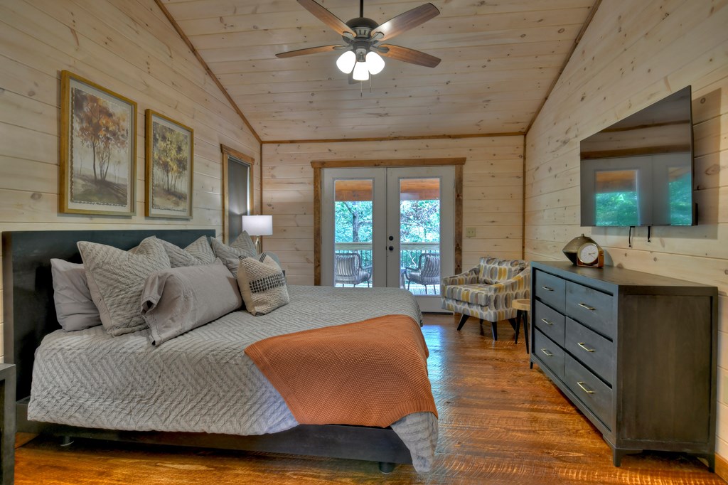 135 Windy Valley Lane Blue Ridge, GA 30513 - Photo 18 of 63 a bedroom with furniture and a large window