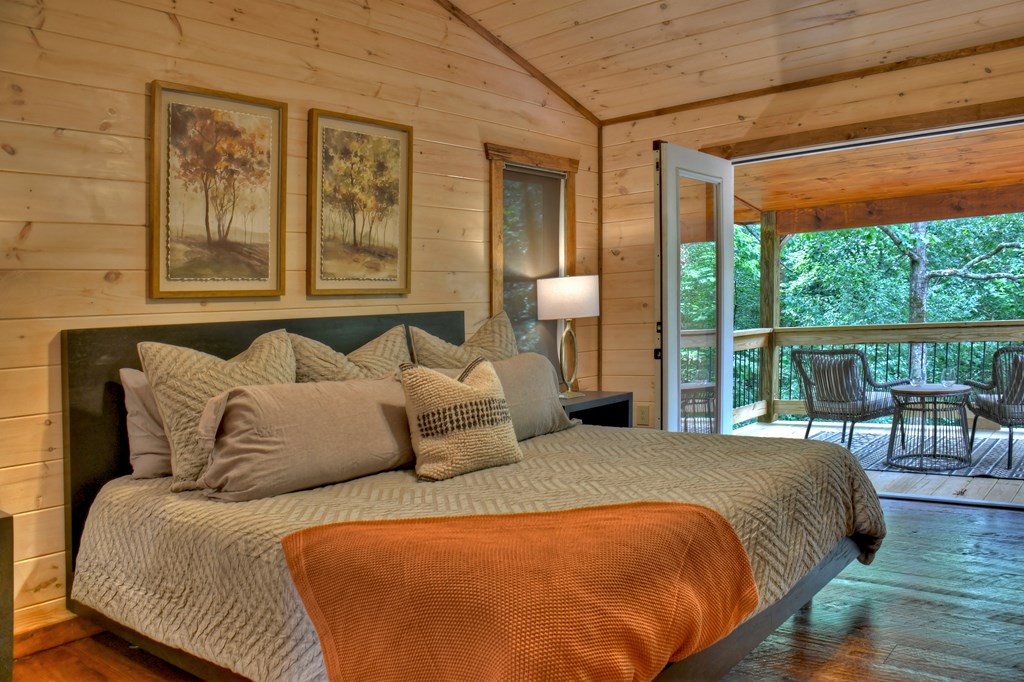 135 Windy Valley Lane Blue Ridge, GA 30513 - Photo 20 of 63 a bedroom with a bed and wooden floor