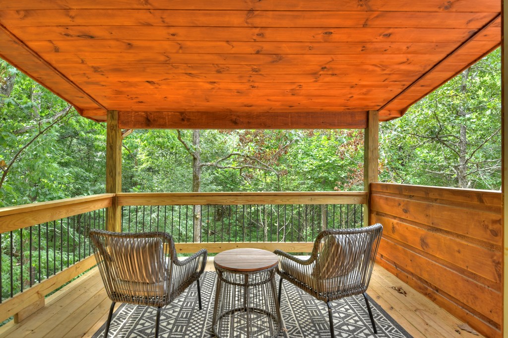 135 Windy Valley Lane Blue Ridge, GA 30513 - Photo 21 of 63 a view of a chair and table in the balcony