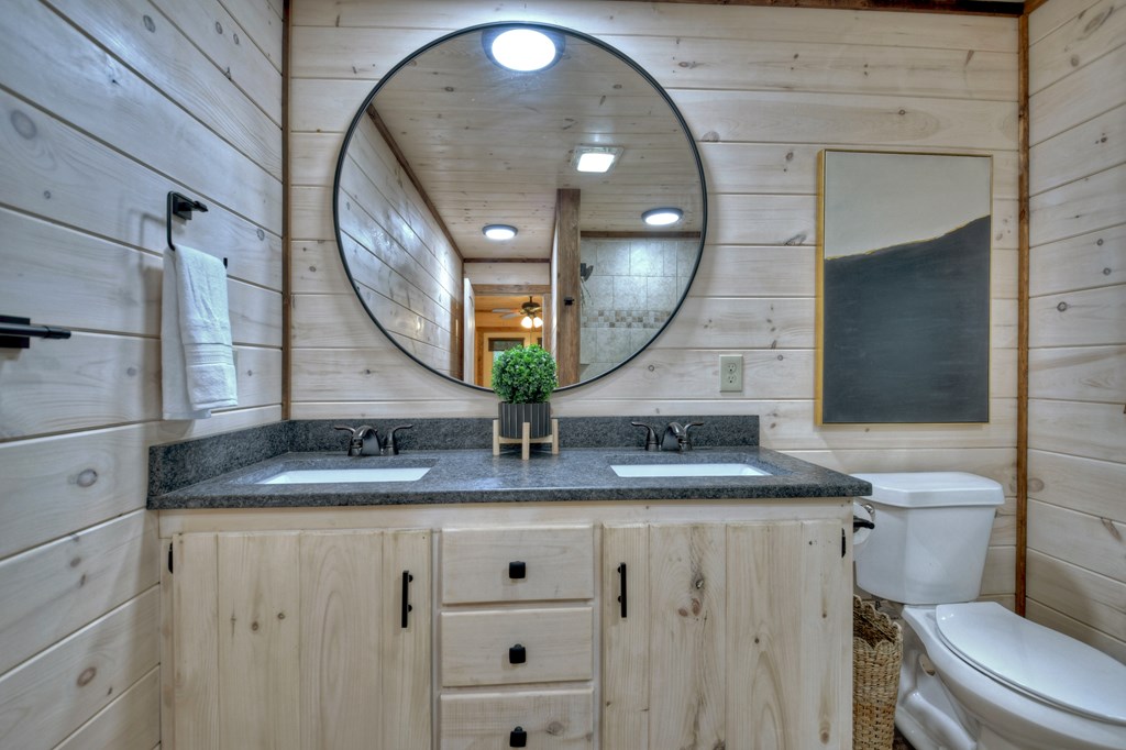 135 Windy Valley Lane Blue Ridge, GA 30513 - Photo 29 of 63 a bathroom with a granite countertop toilet sink and mirror