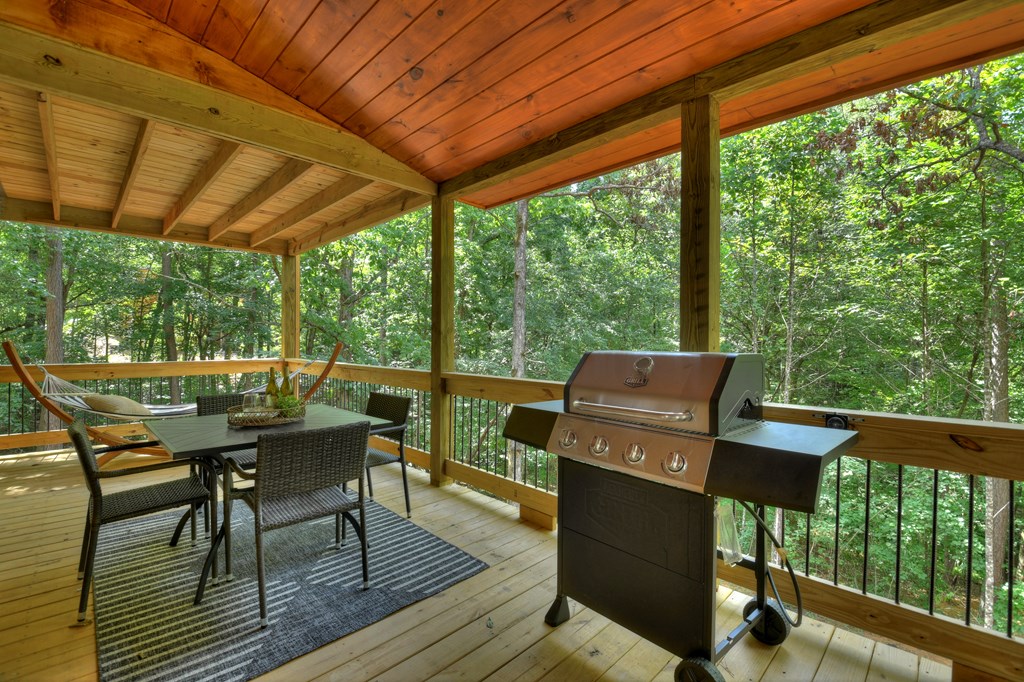 135 Windy Valley Lane Blue Ridge, GA 30513 - Photo 32 of 63 a view of a patio with table and chairs