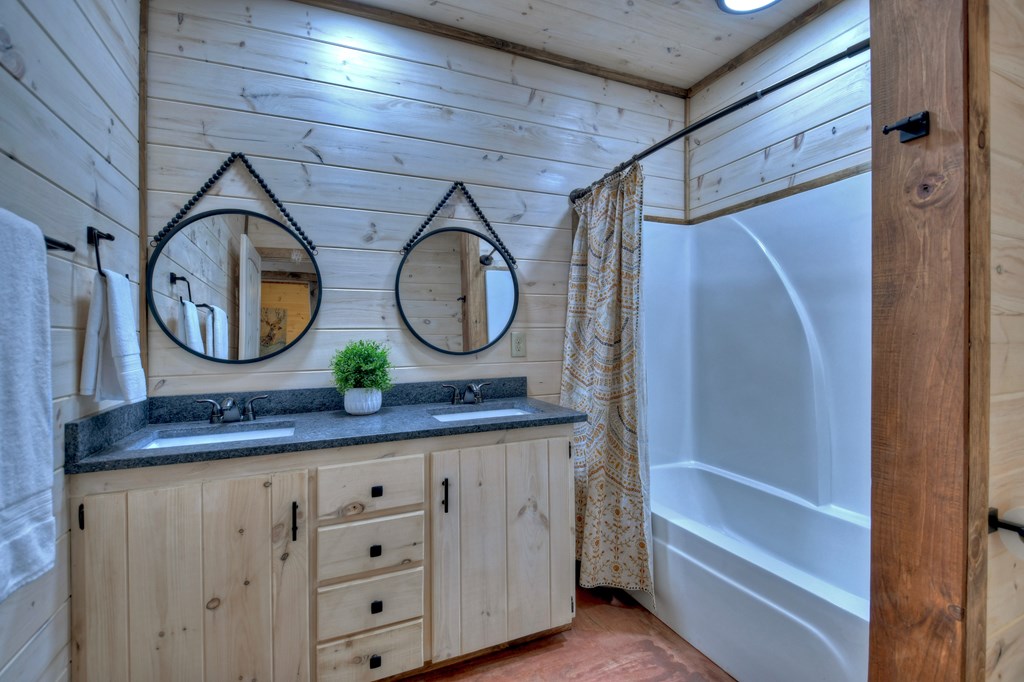 135 Windy Valley Lane Blue Ridge, GA 30513 - Photo 55 of 63 a bathroom with a mirror and a sink