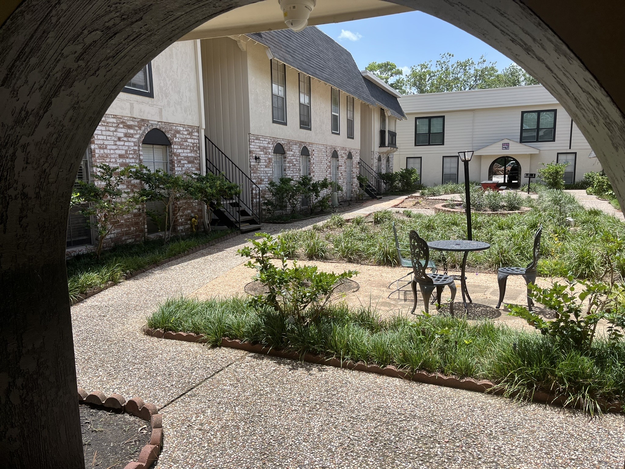 1275 Witte Road, Unit 14 Houston, TX 77055 - Photo 2 of 13 a view of a patio with table and chairs and potted plants