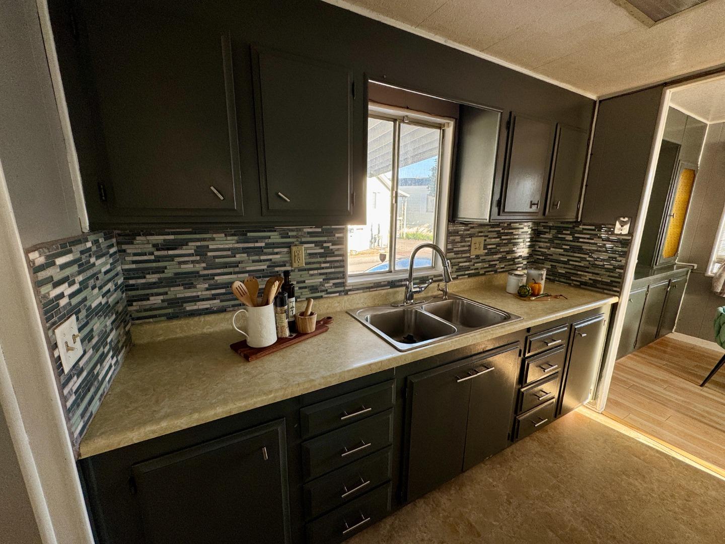 411 Lewis Road, Unit 256 San Jose, CA 95111 - Photo 6 of 12 a kitchen with sink a stove and cabinets