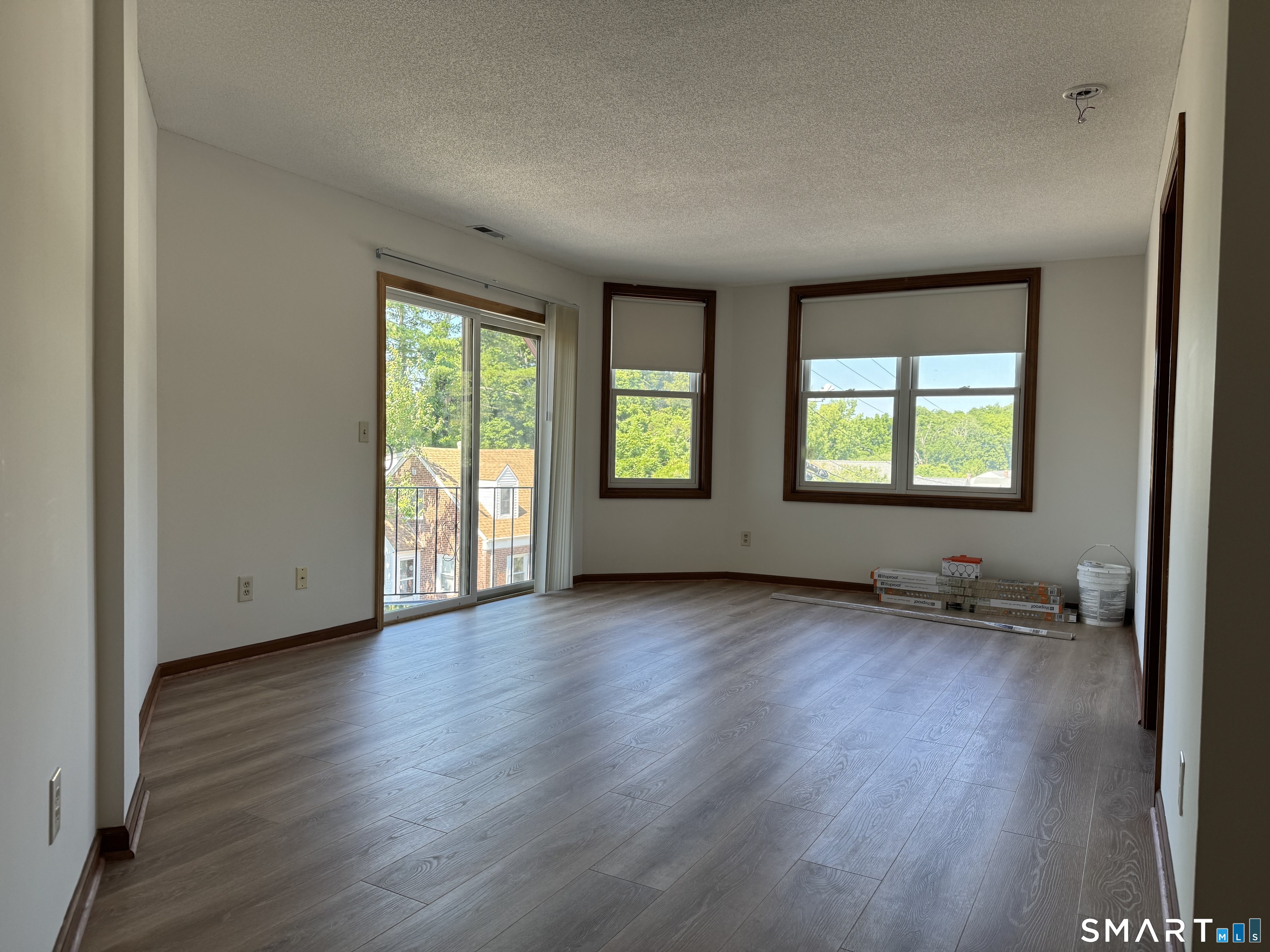 1022 Main Street, Unit 7 Branford, CT 06405 - Photo 10 of 10 an empty room with wooden floor and windows