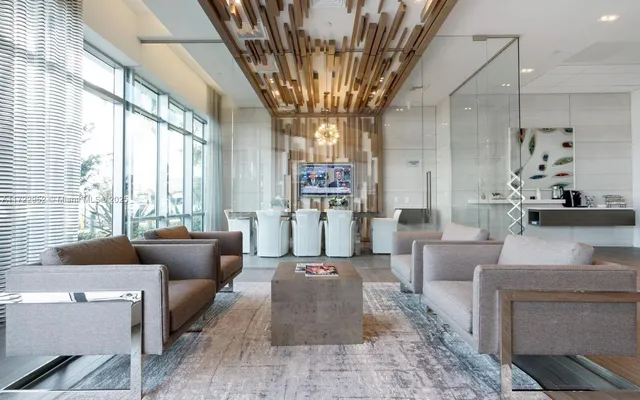 a living room with stainless steel appliances kitchen island granite countertop a sink and cabinets