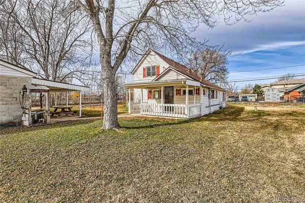 a view of a house with cars parked in front of house