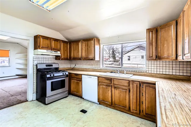 a kitchen with a sink stove and cabinets