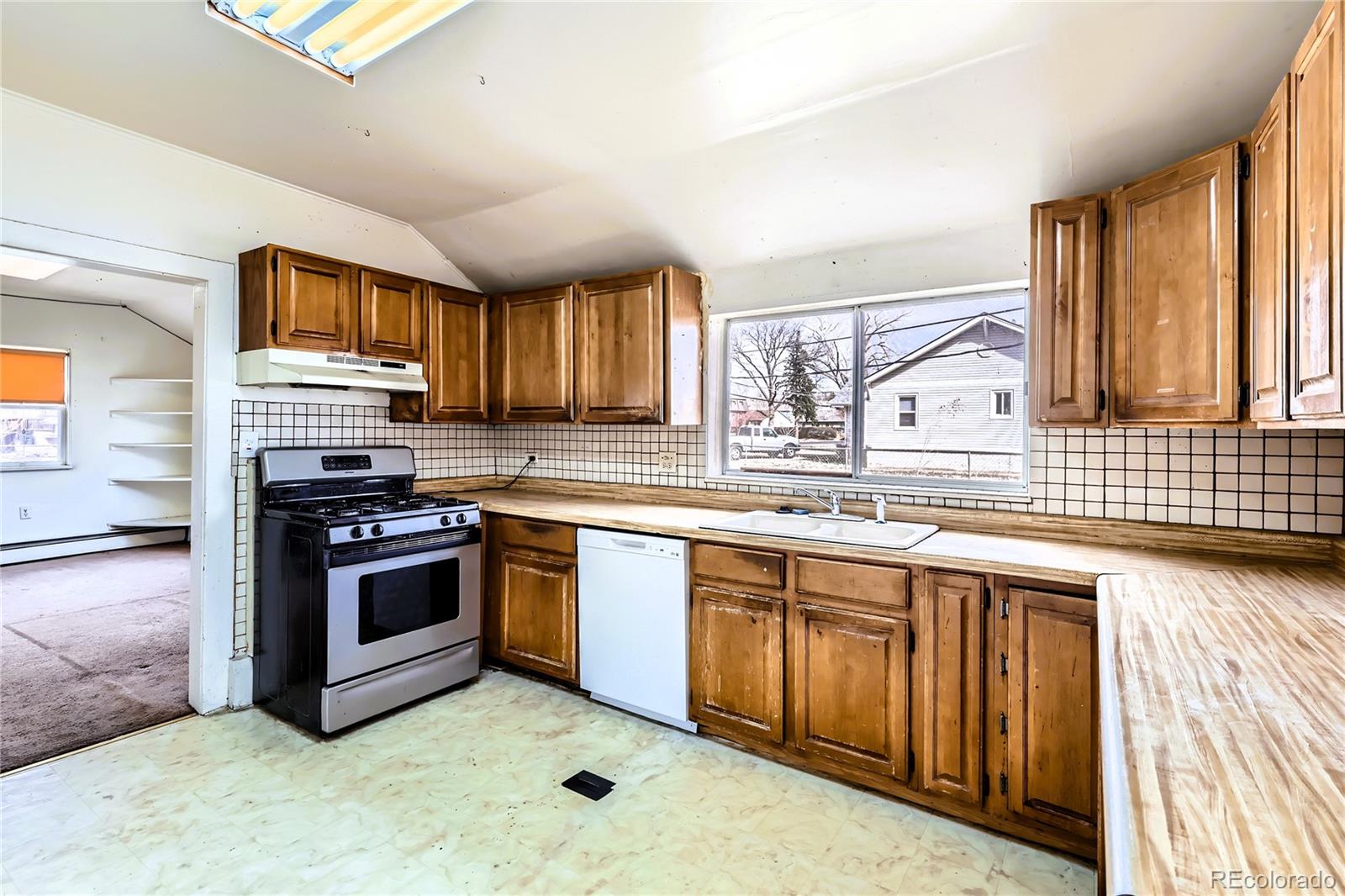 5300 Balsam Street Arvada, CO 80002 - Photo 15 of 29 a kitchen with stainless steel appliances granite countertop a stove sink and microwave