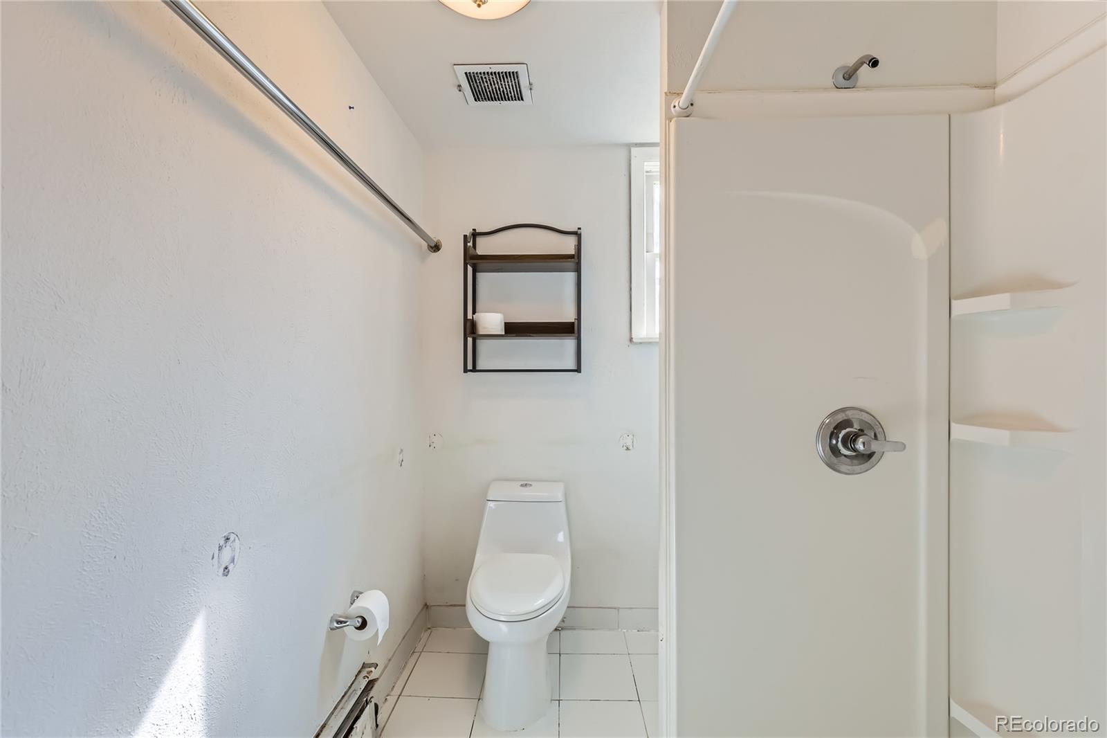 5300 Balsam Street Arvada, CO 80002 - Photo 19 of 29 a white toilet sitting next to a shower