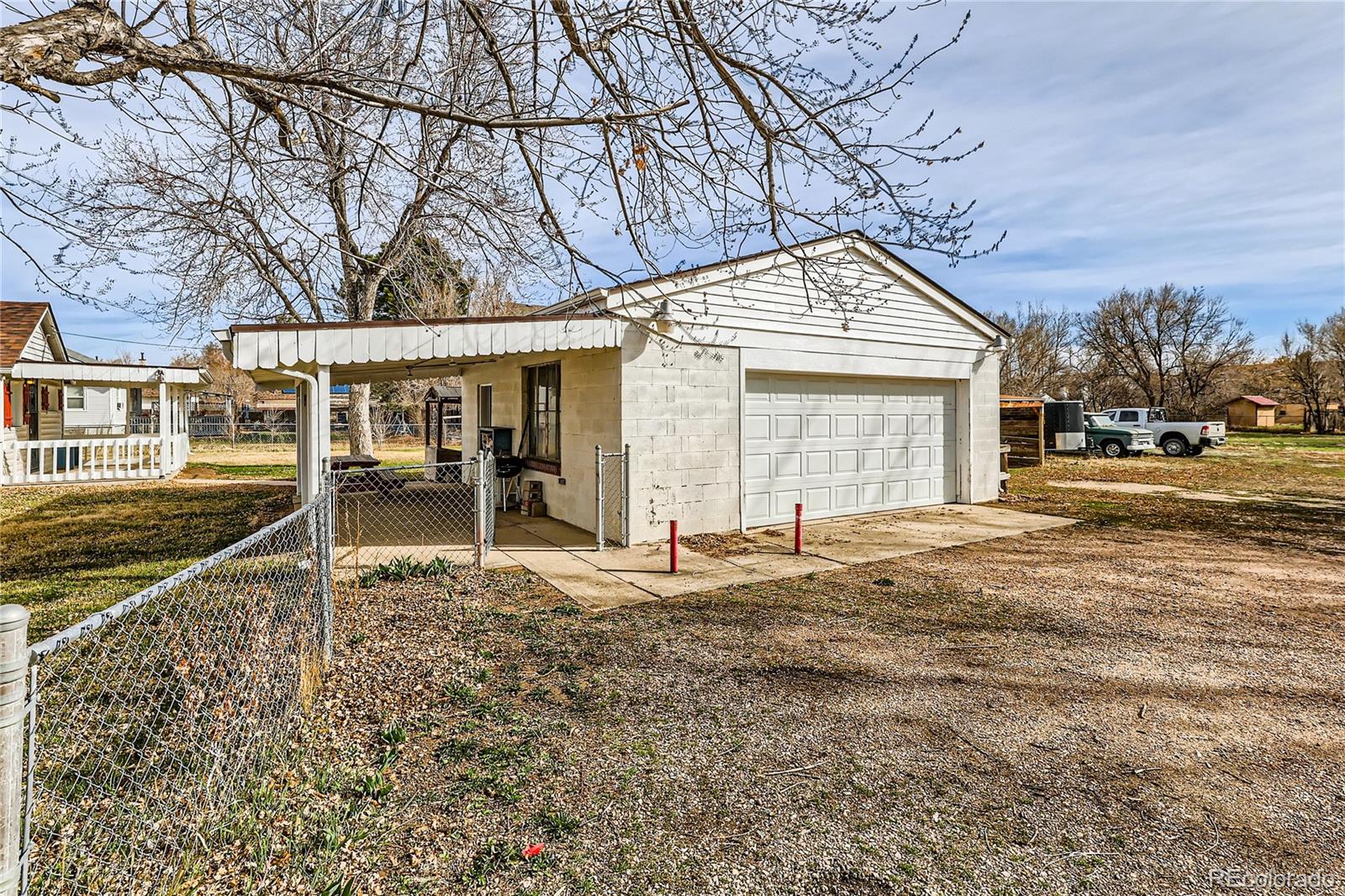 5300 Balsam Street Arvada, CO 80002 - Photo 2 of 29 a backyard of a house with large trees and outdoor seating