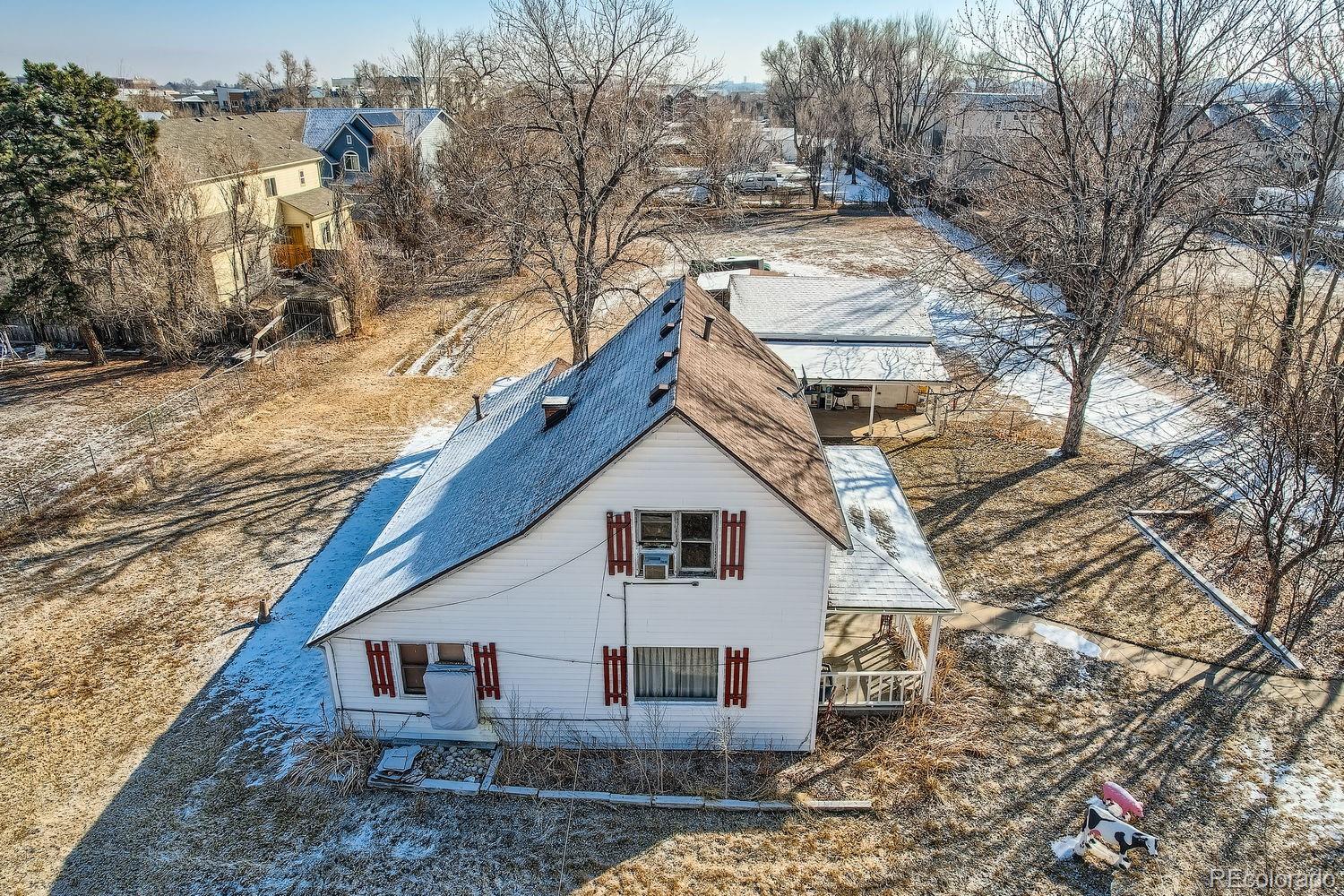 5300 Balsam Street Arvada, CO 80002 - Photo 29 of 29 a view of a house with a yard covered in snow