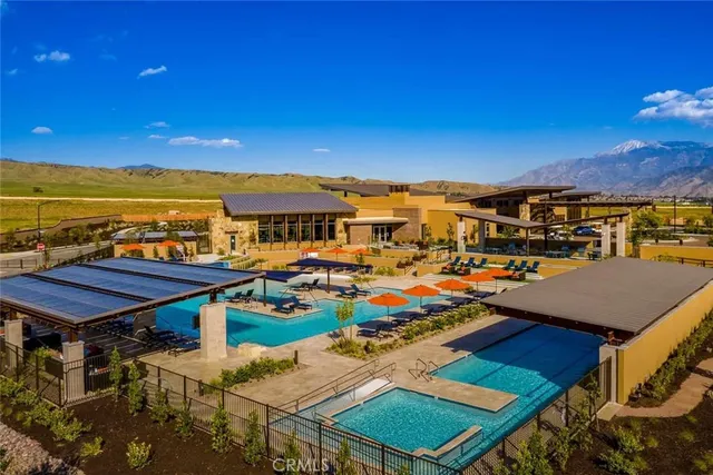 a view of a swimming pool with lawn chairs