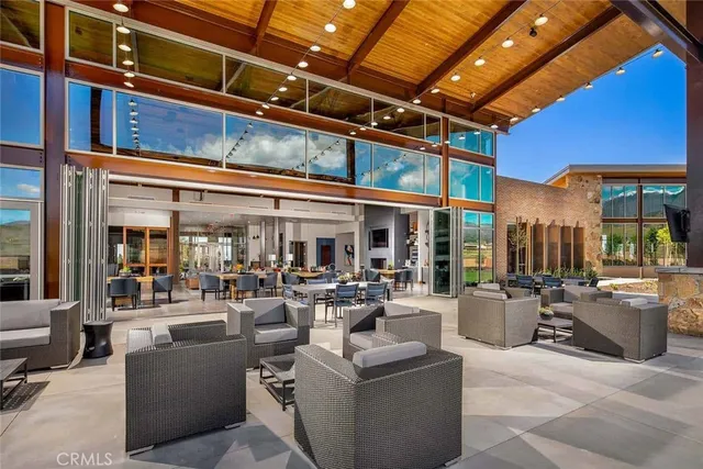 a living room with furniture and large windows