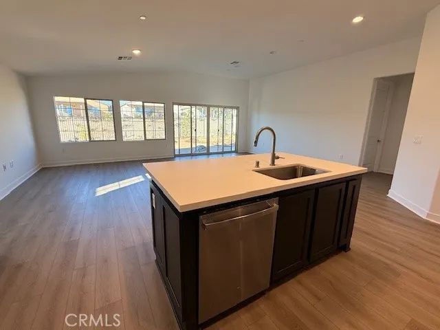 a kitchen with wooden cabinets a sink and dishwasher
