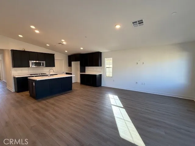 a view of kitchen with microwave and cabinets
