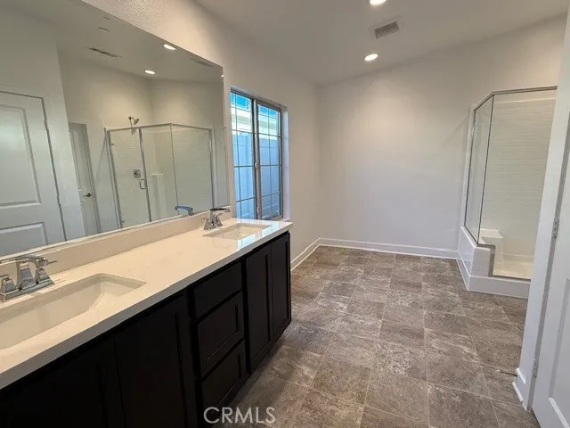 a bathroom with a double vanity sink a and mirror