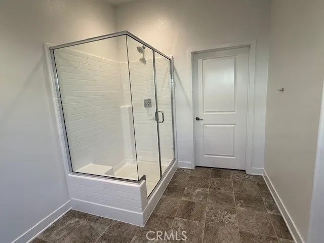 a bathroom with a glass shower door