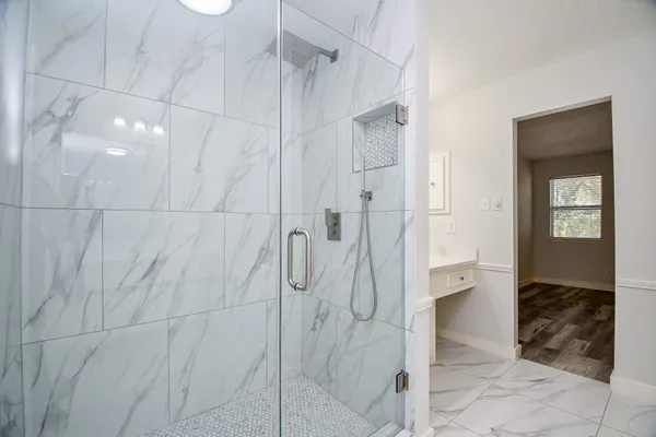 a bathroom with a shower and a sink